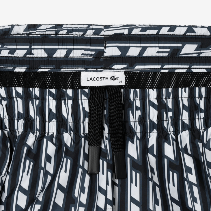 Жене панталоне са логом штампе 86882395 црно плаво бело зи8 Lacoste