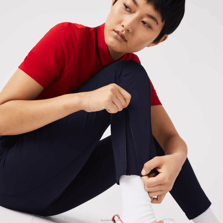 Жене спортске растезљиве панталоне за голф 86882658 тамноплава 166 Lacoste